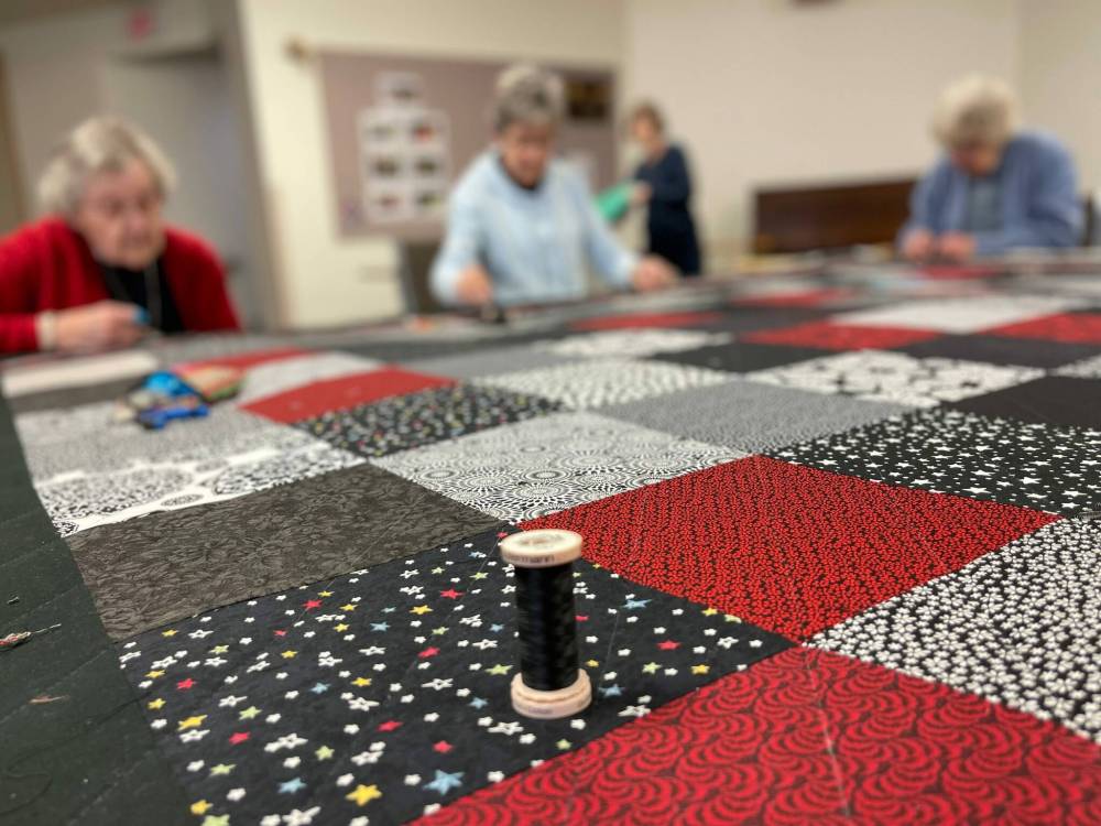 Piece It Together, a group of volunteers who make quilts for Mennonite Central Committee. They are gearing up for a Christmas sale that is happening later this month. (Corné du Preez photo)
