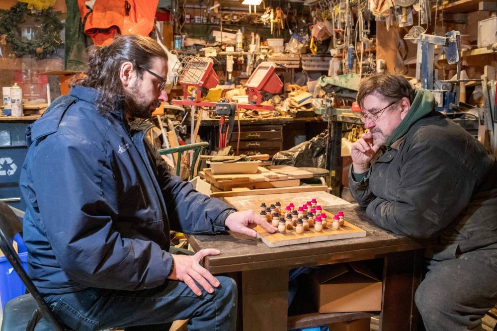 BROOK JONES / WINNIPEG FREE PRESS
Nick (left) and his father Bill play a game of checkers on a board and with pieces they handmade. The wood board is made of oak and the pieces made of maple.