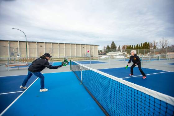 Muyrna Kereluk (left) and Cecile LeBlanc play pickleball at Jill Officer Park in North Kildonan on Monday. (Mikaela MacKenzie / Winnipeg Free Press)