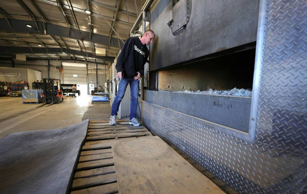 RUTH BONNEVILLE / WINNIPEG FREE PRESS
                                Precious Pet Cremation co-owner Kevin McIver with one of the business’s incinerators. The family-run operation in the RM of Rosser was founded by his parents, Iain and Connie McIver, in the late 1980s.