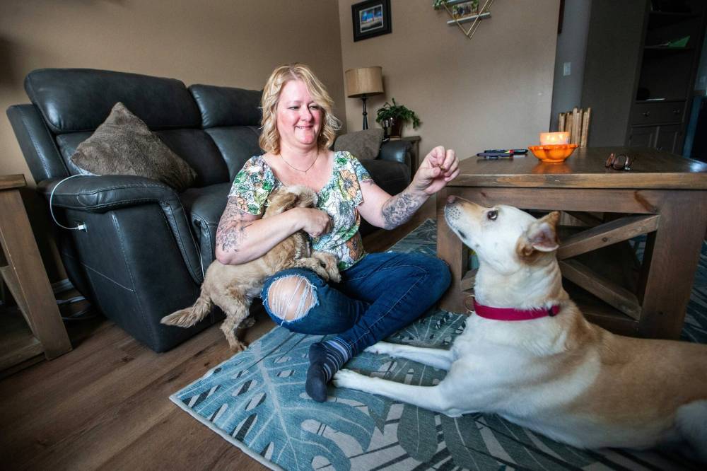 MIKAELA MACKENZIE / WINNIPEG FREE PRESS
                                Christine Klassen with Sam and Archie. After Klassen’s dog Lucy died, she got a tattoo to memorialize her longtime companion.