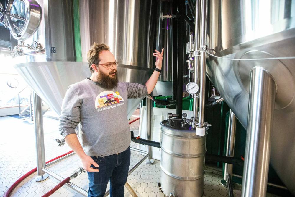 MIKAELA MACKENZIE / WINNIPEG FREE PRESS
Head of brewery operations, Rob McWhinney, shows a component of the new CiCi Carbon Recapture System in the fermentation vat area at the Little Brown Jug brewery on Tuesday.