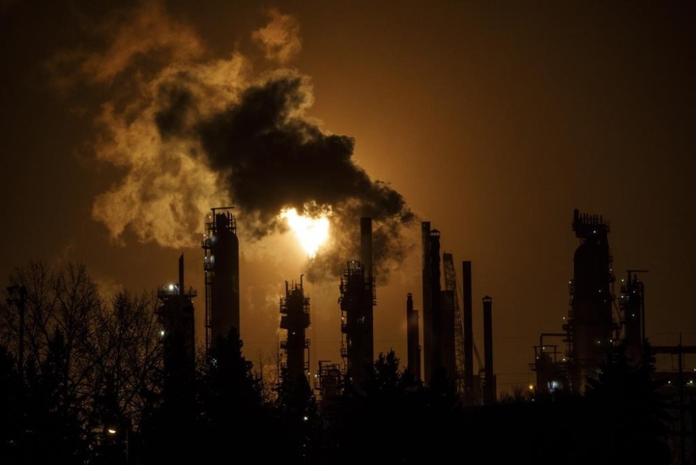 Canada and other major fossil-fuel-producing countries are failing to meet targets to keep global warming in check, a newly released major international report warned Wednesday, putting the world’s energy transition at risk. A flare stack lights the sky from a refinery in Edmonton on Friday, Dec. 28, 2018. THE CANADIAN PRESS/Jason Franson