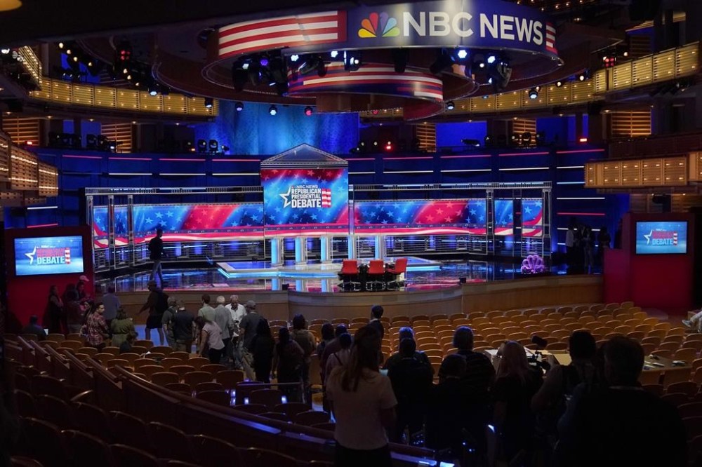 Photographers check out the stage during a walk through, Tuesday, Nov. 7, 2023, for the third Republican presidential debate in Miami. Five hopefuls will participate in the debate at the Adrienne Arsht Center for the Performing Arts of Miami-Dade County, according to the Republican National Committee. They are Florida Gov. Ron DeSantis, businessman Vivek Ramaswamy, former U.N. Ambassador Nikki Haley, Sen. Tim Scott, R-S.C., and former New Jersey Gov. Chris Christie. (AP Photo/Wilfredo Lee)