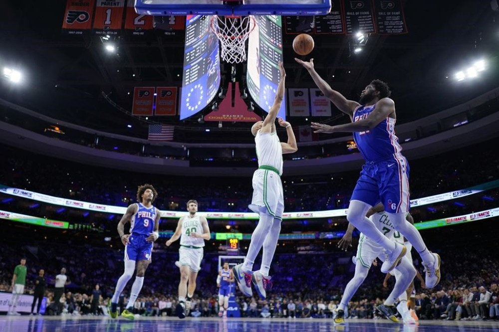 Philadelphia 76ers' Joel Embiid, right, goes up for a shot against Boston Celtics' Derrick White during the first half of an NBA basketball game, Wednesday, Nov. 8, 2023, in Philadelphia. (AP Photo/Matt Slocum)