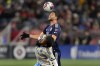 New England Revolution midfielder Matt Polster, top, heads the ball away while leaning on the back of Philadelphia Union midfielder JosÈ AndrÈs MartÌnez, bottom, during the first half of an MLS playoff soccer game, Wednesday, Oct. 8, 2023, in Foxborough, Mass. (AP Photo/Charles Krupa)