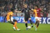 Galatasaray's Sacha Boey, right, and Davinson Sanchez, left, challenge for the ball with Bayern's Harry Kane during the Champions League group A soccer match between Bayer Munich and Galatasaray at the Allianz Arena stadium in Munich, Germany, Wednesday, Nov. 8, 2023. (AP Photo/Matthias Schrader)