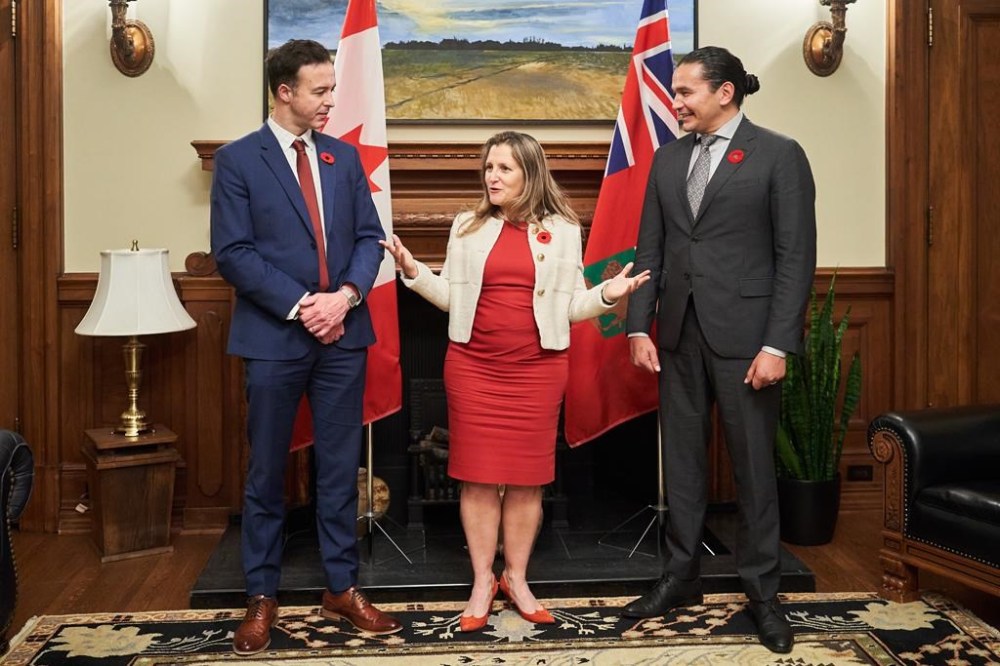 Deputy Prime Minister and Finance Minister Chrystia Freeland, centre, meets with Manitoba Premier, Wab Kinew, right, and Manitoba's Minister of Finance, Adrien Sala at the Manitoba Legislative Building in Winnipeg on Wednesday, Nov. 8, 2023. THE CANADIAN PRESS/David Lipnowski