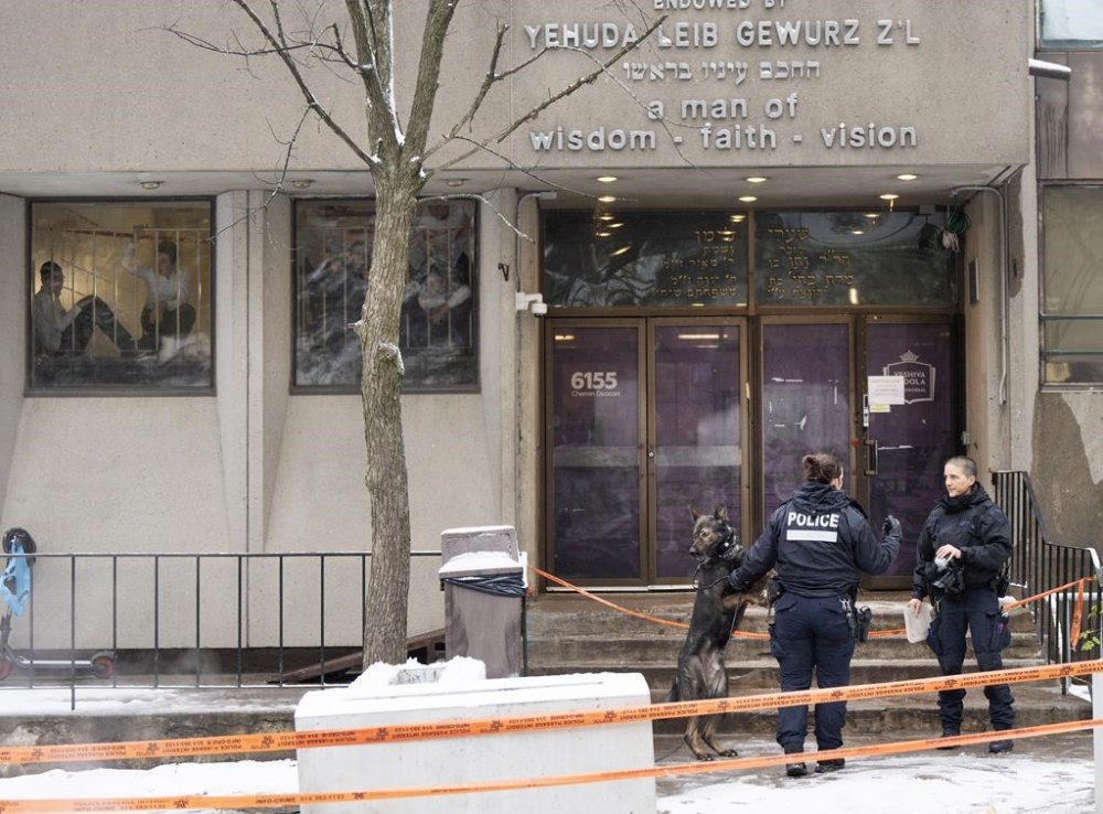 Police investigate the Yeshiva Gedolah school for clues after shots were fired at two Jewish schools Thursday, Nov. 9, 2023, in Montreal. Montreal police say two Jewish schools in the city were hit overnight by gunshots. Police say nobody was inside at the time of the shootings. THE CANADIAN PRESS/Ryan Remiorz
