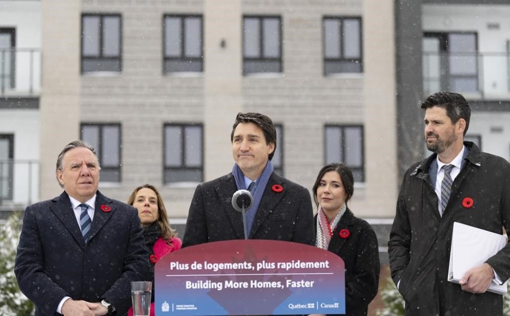 Prime Minister Justin Trudeau, centre, makes a housing announcement with Quebec Premier Francois Legault, left, in Longueuil, Que., Thursday Nov. 9, 2023. The federal government announced $900-million federal contribution over the next four years to accelerate housing construction in Quebec. THE CANADIAN PRESS/Christinne Muschi