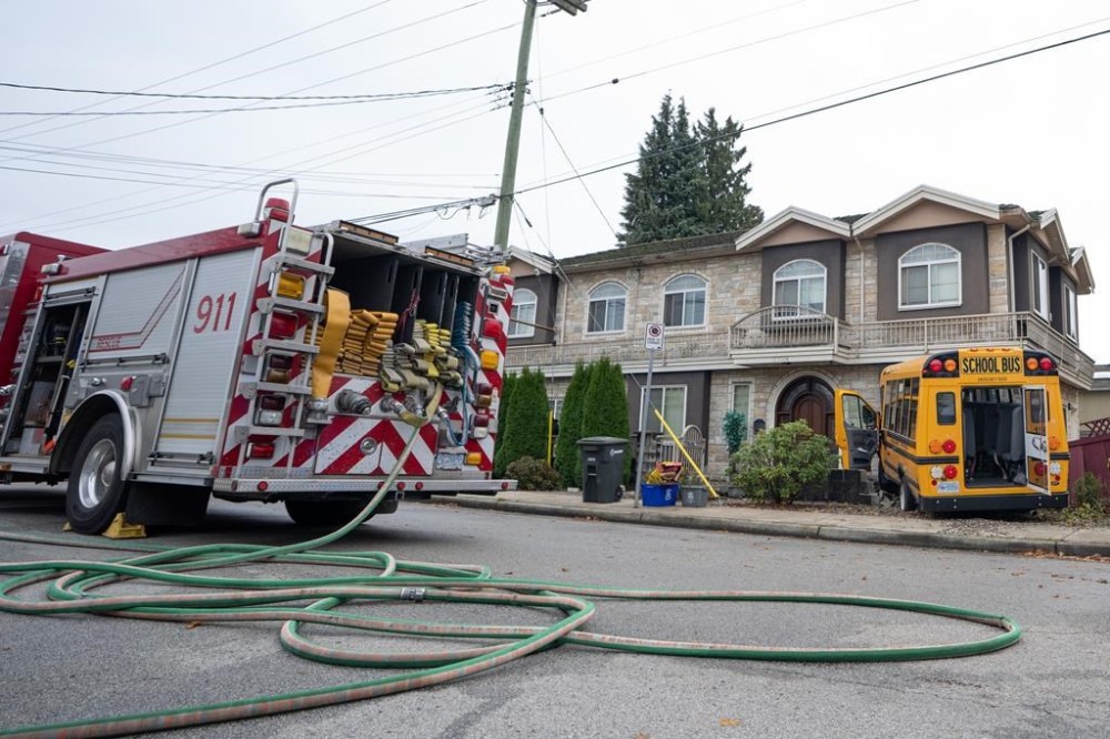 A school bus that crashed into a home on 16th Ave in Burnaby B.C. is shown on Thursday, Nov. 9, 2023. Eleven people have been sent to hospital. BC Emergency Health Services says in a statement that all 11 patients are in stable condition. Health Services says the call came in just before 8 a.m. today about the accident. THE CANADIAN PRESS/Ethan Cairns
