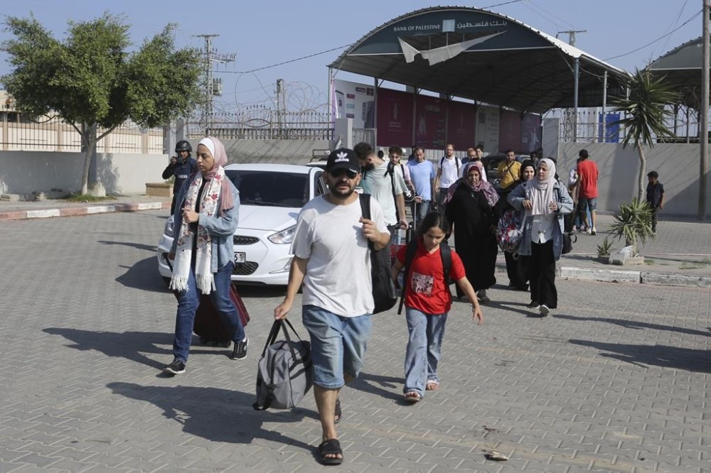 Palestinians cross to the Egyptian side of the border with the Gaza Strip Wednesday, Nov. 1, 2023. in Rafah Wednesday, Nov. 1, 2023. (AP Photo/Hatem Ali)