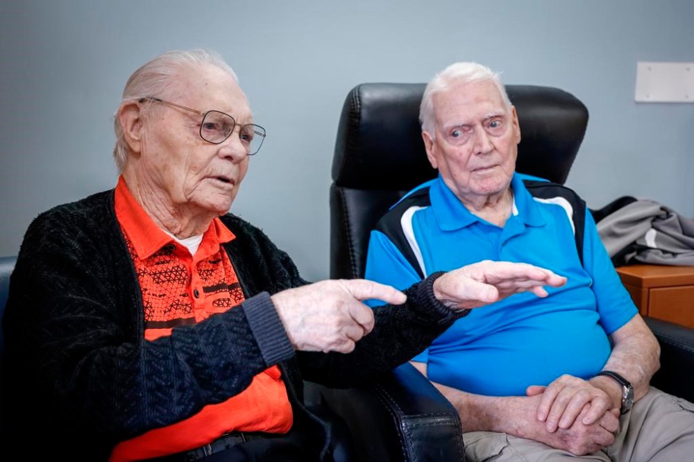 Royal Canadian Air Force veteran Bill Cook, left, describes his first combat mission as fellow veteran Hank Jackson, 102, looks on in Calgary, Tuesday, Nov. 7, 2023. Both were Halifax bomber tail gunners during World War II. THE CANADIAN PRESS/Jeff McIntosh