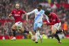 FILE - Crystal Palace's Eberechi Eze, center, dribbles the ball past Manchester United's Sofyan Amrabat, left, and Victor Lindelof during the English Premier League soccer match between Manchester United and Crystal Palace at the Old Trafford stadium stadium in Manchester, England, Saturday, Sept. 30, 2023. Crystal Palace midfielder Eberechi Eze has signed a contract extension to stay with the Premier League club until 2027. “I’m loving every moment,” the 25-year-old England international said in the club's announcement on Friday, Nov. 10, 2023. (AP Photo/Jon Super, File)