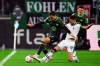 Gladbach's Julian Weigl, right, and Wolfsburg's Jonas Wind battle for the ball during the Bundesliga soccer match between Borussia Monchengladbach and VfL Wolfsburg at Borussia-Park stadium, Monchengladbach, Germany, Friday Nov. 10, 2023. (Federico Gambarini/dpa via AP)