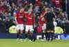 Manchester United's Christian Eriksen, second left, goes off injured during the Premier League match between Manchester United and Luton at Old Trafford, Manchester, England, Saturday Nov. 11, 2023. (Martin Rickett/PA via AP)