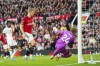 Manchester United's Rasmus Hojlund, centre, makes an attempt to score past Luton Town's goalkeeper Thomas Kaminski during the English Premier League soccer match between Manchester United and Luton Town at the Old Trafford stadium in Manchester, England, Saturday, Nov. 11, 2023. (AP Photo/Jon Super)