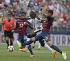 FILE - United States' Kellyn Acosta, left, and Matt Hedges, right, pressure Ghana's Raphael Dwamena, center, during the first half of an international friendly soccer match at Pratt & Whitney Stadium at Rentschler Field, Saturday, July 1, 2017, in East Hartford, Conn. Former Ghana striker Raphael Dwamena has died after collapsing Saturday, Nov. 11, 2023, during an Albanian Super League soccer match. (AP Photo/Jessica Hill, FIle)