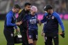 OL Reign forward Megan Rapinoe is helped up by team officials after an injury during the first half of the NWSL Championship soccer game against NJ/NY Gotham, Saturday, Nov. 11, 2023, in San Diego. (AP Photo/Gregory Bull)