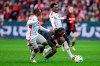 Berlin's Jerome Roussillon, left, and Sheraldo Becker, right, challenge for the ball with Leverkusen's Jeremie Frimpong, center, during the German Bundesliga soccer match between Bayer 04 Leverkusen and Union Berlin in Leverkusen, Germany, Sunday, Nov. 12, 2023. (David Inderlied/dpa via AP)