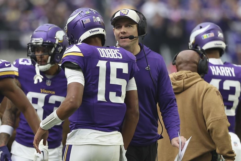 Minnesota Vikings quarterback Joshua Dobbs (15) talks with head coach Kevin O'Connell during the first half of an NFL football game against the New Orleans Saints Sunday, Nov. 12, 2023, in Minneapolis. (AP Photo/Matt Krohn)