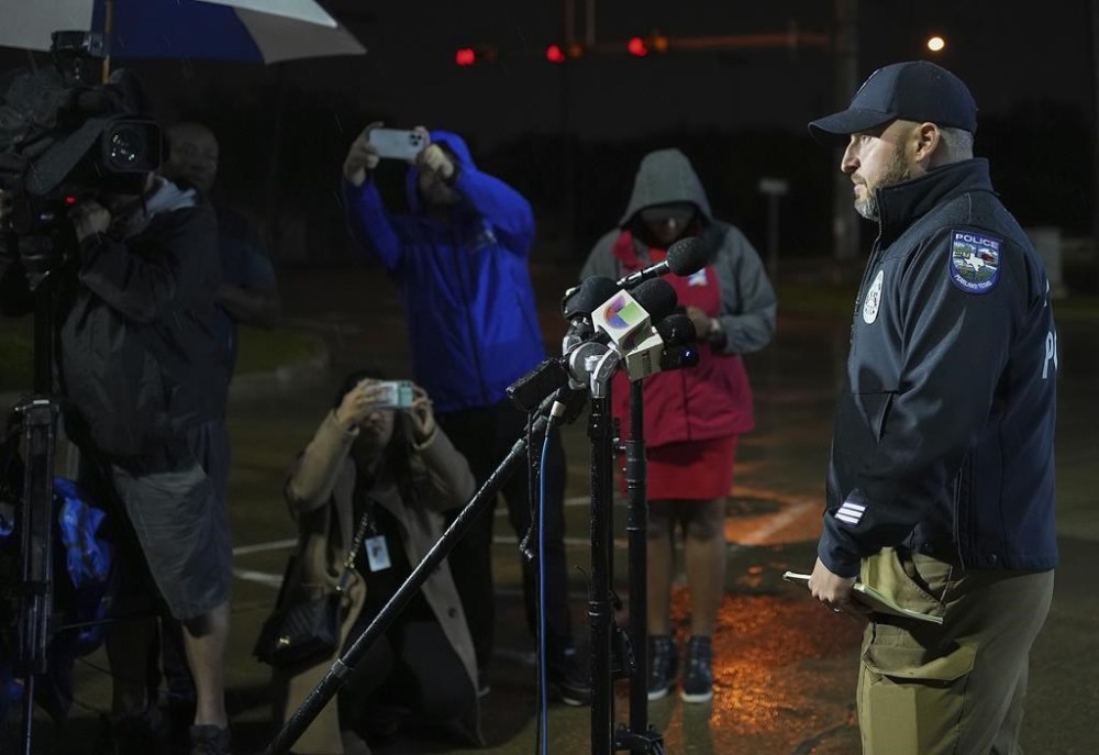 Chad Rogers, public informational officer for Pearland Police Department, gives a statement to the media after a shooting outside Cole's Antique Village and Flea Market, Sunday, Nov. 12, 2023, in Pearland, Texas, near Houston. A manhunt was underway late Sunday after a gunman shot at least five people outside the flea market. The five, identified by police as three adults and two juveniles, were taken to local hospitals, Pearland police said. (Elizabeth Conley/Houston Chronicle via AP)