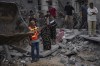 Palestinians look for survivors following an Israeli airstrike in Khan Younis, southern Gaza Strip, Sunday, Nov. 12, 2023. ( AP Photo/Fatima Shbair)