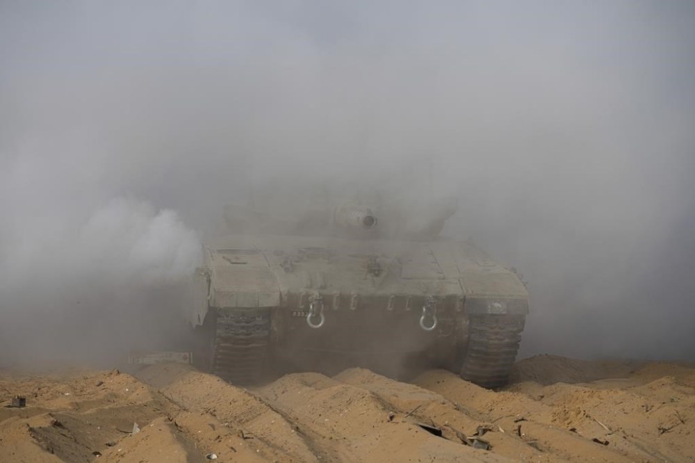 Israeli tanks manoeuvre near the Israeli-Gaza border, southern Israel, Monday, Nov. 13, 2023. (AP Photo/Tsafrir Abayov)
