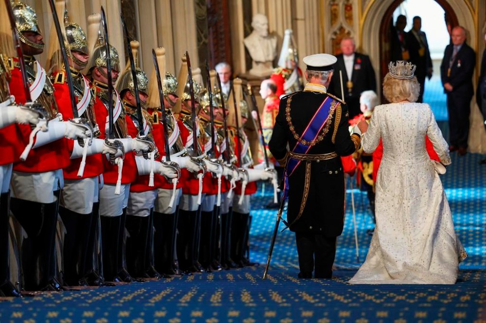 FILE - Britain's King Charles III and Queen Camilla leave after the State Opening of Parliament at the Houses of Parliament, in London, Tuesday, Nov. 7, 2023. At an age when many of his contemporaries have long since retired, King Charles III is not one to put his feet up. The king will mark his 75th birthday on Tuesday, Nov. 14, 2023, by highlighting causes close to his heart. With Queen Camilla at his side, Charles will visit a project that helps feed those in need by redistributing food that might otherwise go to landfills. (Toby Melville/Pool Photo via AP, File)