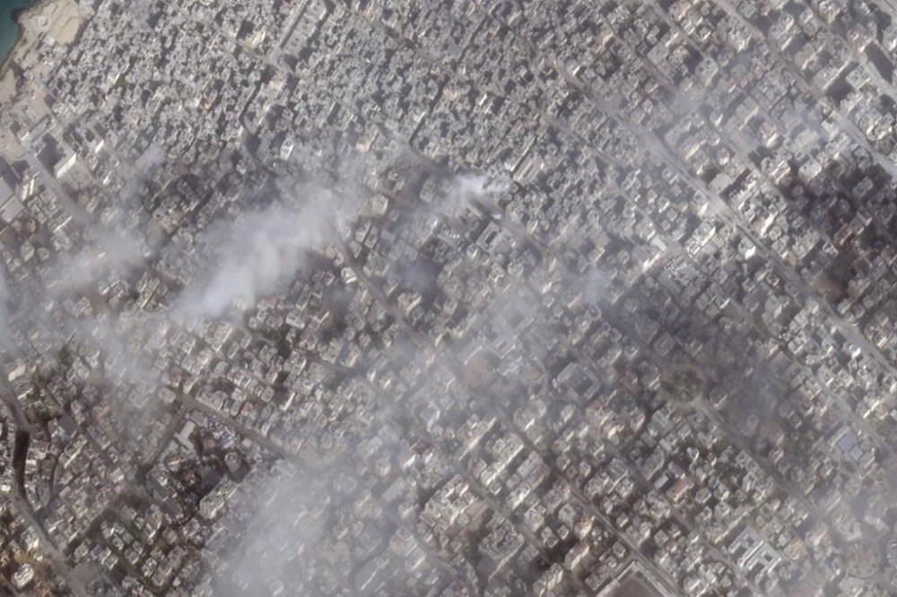 This satellite photo from Planet Labs PBC shows fires in Gaza City in Gaza Strip on Saturday, Nov. 11, 2023. Israeli tanks and armored vehicles pushed further into the Gaza Strip late last week as part of an offensive squeezing Gaza City as fighting raged between its forces and Hamas militants in the coastal enclave, satellite photos analyzed Tuesday, Nov. 14, 2023, by The Associated Press show. The besieged Shifa Hospital compound can be seen in the bottom lefthand corner of the image. (Planet Labs PBC via AP)