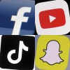 This combination of 2017-2022 photos shows the logos of Facebook, YouTube, TikTok and Snapchat on mobile devices. THE CANADIAN PRESS/AP