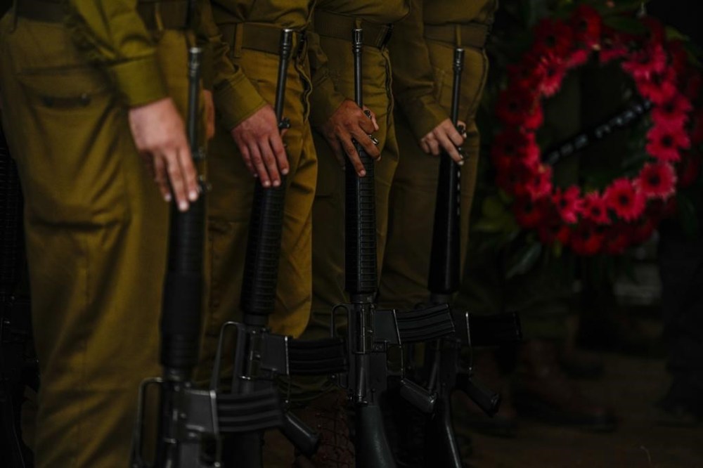 Israeli honor guard soldiers attend the funeral of Israeli reserve soldier Master sergeant Raz Abulafia during his funeral in the village of Rishpon, Israel, Tuesday, Nov. 14, 2023. Abulafia, 27, was killed during a military ground operation in the Gaza Strip. (AP Photo/Ariel Schalit)