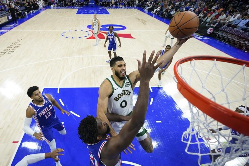 Boston Celtics' Jayson Tatum, right, goes up against Philadelphia 76ers' Joel Embiid during the second half of an NBA basketball game, Wednesday, Nov. 15, 2023, in Philadelphia. (AP Photo/Matt Slocum)