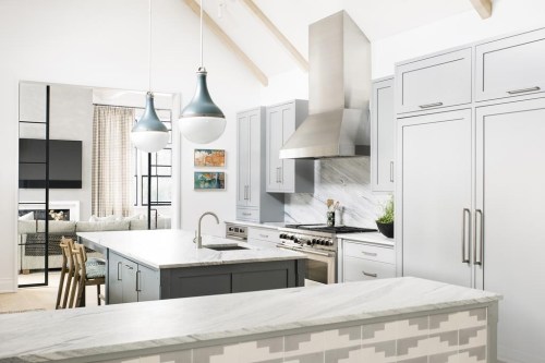 This image released by designer Cortney Bishop shows a kitchen outside of New York that was inspired by the owner's visit to Sullivan Island in South Carolina. The distinctive patterned tile is from Exquisite Surface’s Commune collection. (Cortney Bishop via AP)