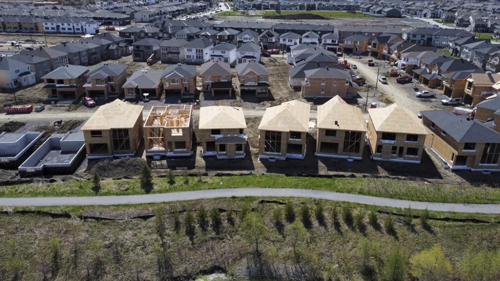 Canada Mortgage and Housing Corp. says the annual pace of housing starts for October ticked up from September. New homes are built in a housing development in the west end of Ottawa on Thursday, May 6, 2021. THE CANADIAN PRESS/Sean Kilpatrick