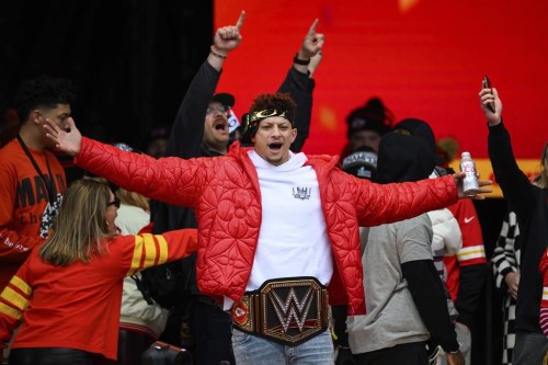 File - Kansas City Chiefs Patrick Mahomes, wearing a WWE belt, celebrates the team's Super Bowl victory at a gathering in Kansas City, Mo., Wednesday, Feb. 15, 2023. The WWE is collaborating with the Big 12 Conference for their championship game next month, as the sports entertainment company further strengthens its relationship with various sports organizations. The Dr. Pepper Big 12 Football Championship will be held on Dec. 2, 2023 at AT&T Stadium in Arlington, Texas. (AP Photo/Reed Hoffmann, File)