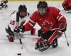 Canada's Billy Bridges, right, and Japan's Kazuhiro Takahashi chase the puck during first period semifinal ice sledge hockey action at the 2010 Winter Paralympics in Vancouver, B.C., on Thursday March 18 2010. Decorated para hockey player Bridges is about to make his international debut in a summer sport. Bridges will throw javelin and shot put in the Parapan American Games. THE CANADIAN PRESS/Darryl Dyck