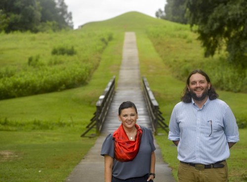 FILE -Tracie Revis, left, a citizen of the Muscogee Creek Nation, and Seth Clark, mayor pro-tem of Macon, stand near the Earth Lodge, where Native Americans met for a 1,000 years until their forced removal in the 1820s, on Aug. 22, 2022, in Macon, Ga. A National Park Service study released Thursday, Nov. 16, 2023 provides Congress with a road map to federally protecting land along 50 miles of the Ocmulgee River. (AP Photo/Sharon Johnson, File)
