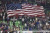 Fans wave a U.S. flag at the start of the first leg of a CONCACAF Nations League soccer quarterfinal between the United States and Trinidad and Tobago on Thursday, Nov. 16, 2023, in Austin, Texas. (AP Photo/Stephen Spillman)
