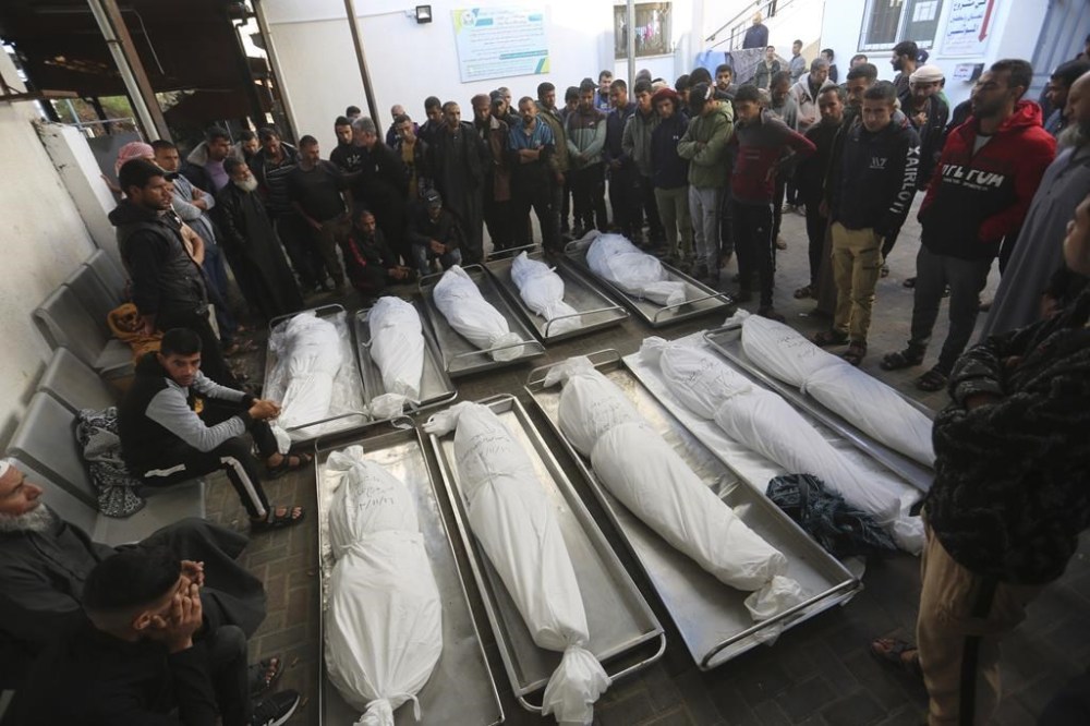 Palestinians mourn over the bodies of relatives killed in the Israeli bombardment of the Gaza Strip in Rafah on Friday, Nov. 17, 2023. (AP Photo/Hatem Ali)