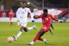 Canada midfielder Alphonso Davies (19) kicks the ball past Honduras midfielder Oscar Almendarez (19) during first half CONCACAF Nations League soccer action in Toronto on Tuesday, March 28, 2023.&nbsp;Heavy rains forced the postponement of Friday night’s CONCACAF Nations League quarterfinal match between Canada and Jamaica at Independence Park. THE CANADIAN PRESS/Nathan Denette