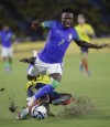Brazil's Vinicius Junior, front, and Colombia's Davison Sanchez fight for the ball during a qualifying soccer match for the FIFA World Cup 2026 at Roberto Melendez stadium in Barranquilla, Colombia, Thursday, Nov. 16, 2023. (AP Photo/Ivan Valencia)