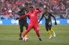 Canada's Jonathan David breaks away from Jamaica's Richard King (left) and Devon Williams during first half CONCACAF World Cup soccer qualifying action in Toronto on Sunday, March 27, 2022. David scored in Canada's 2-1 win over Jamaica on Saturday in Kingston, Jamaica. THE CANADIAN PRESS/Nathan Denette