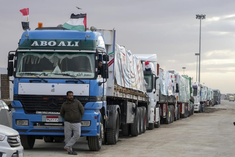 Trucks carrying humanitarian aid line up at the Rafah Border Crossing, Egypt, on the way to Gaza, Sunday, Nov. 19, 2023. (AP Photo/Amr Nabil)