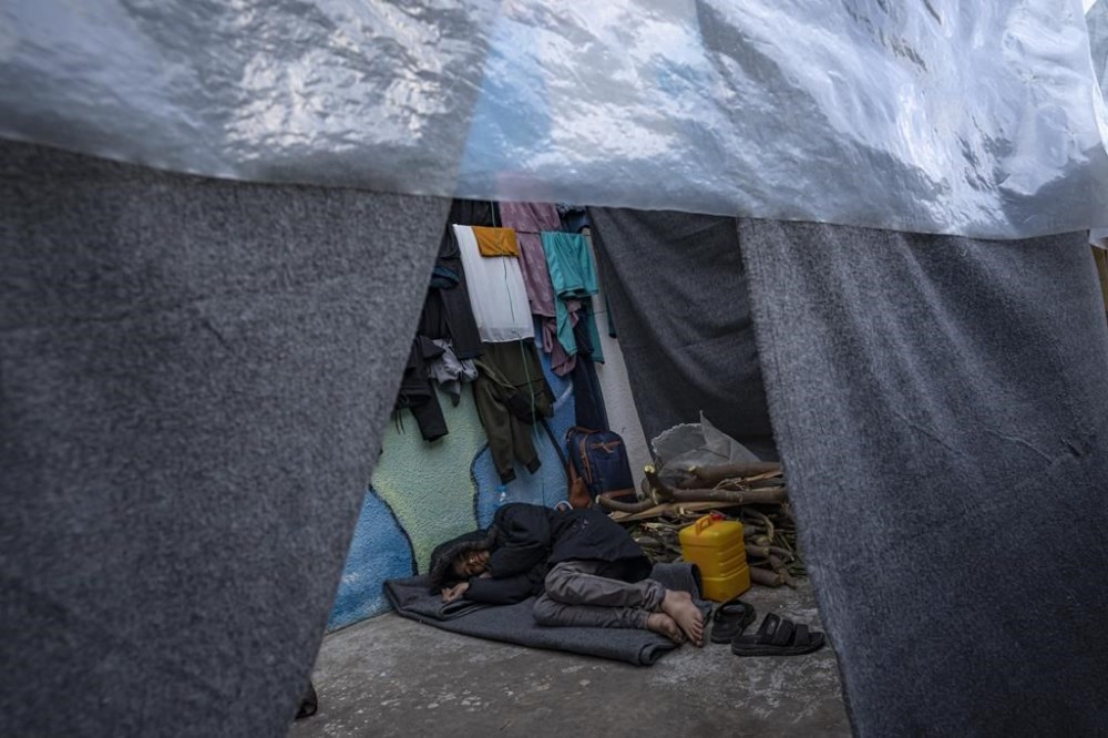 A Palestinian man displaced by the Israeli bombardment of the Gaza Strip rests in a tent at a U.N. displacement camp in Khan Younis, Sunday, Nov. 19, 2023. Hundreds of thousands of Palestinians have fled their homes in northern Gaza as Israel continues its ground offensive against the ruling Hamas militant group. (AP Photo/Fatima Shbair)