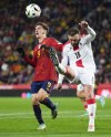 Georgia's Niki Kvekveskiri, right, and Spain's Gavi Paez compete for the ball during the Euro 2024 group A qualifying soccer match between Spain and Georgia at Jose Zorrilla Stadium in Valladolid, Spain, Sunday, Nov. 19, 2023. (AP Photo/Manu Fernandez)