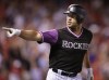 FILE - Colorado Rockies' Matt Holliday points to the Rockies' dugout after hitting a solo home run against the St. Louis Cardinals during the seventh inning of a baseball game Saturday, Aug. 25, 2018, in Denver. Adrián Beltré, Joe Mauer, Chase Utley, David Wright, José Bautista and Matt Holliday are among 12 new candidates on the Hall of Fame's ballot for the Baseball Writers' Association of America.(AP Photo/Joe Mahoney, File)