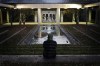 Royce Soble, of Atlanta, sits near a reflection pool at The Carter Center after former first lady Rosalynn Carter has died, Sunday, Nov. 19, 2023, in Atlanta. 