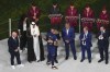 FILE - Qatar Airways staff in uniform, in background, assist in the medal ceremony, as French President Emmanuel Macron hugs France's Kylian Mbappe who was awarded the Golden Boot after the World Cup final soccer match between Argentina and France at the Lusail Stadium in Lusail, Qatar, on Dec. 18, 2022. Qatar Airways will be FIFA’s airline sponsor at the men’s 2026 World Cup being played across North America. Soccer’s governing body renewed with the company through 2030 on Wednesday, Nov. 22, 2023. (AP Photo/Thanassis Stavrakis)