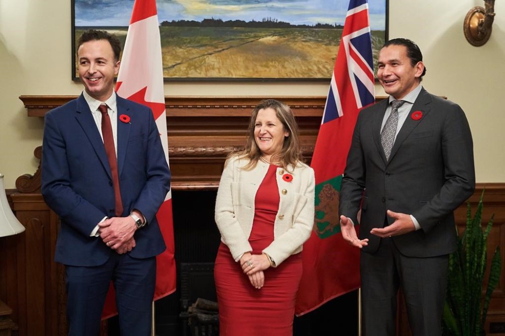 Deputy Prime Minister and Finance Minister Chrystia Freeland, centre, meets with Manitoba Premier Wab Kinew, right and Manitoba's Minister of Finance Adrien Sala at the Manitoba Legislative Building in Winnipeg on Wednesday, Nov. 8, 2023. The Manitoba government has introduced a bill to temporarily lift the provincial tax on fuel. THE CANADIAN PRESS/David Lipnowski